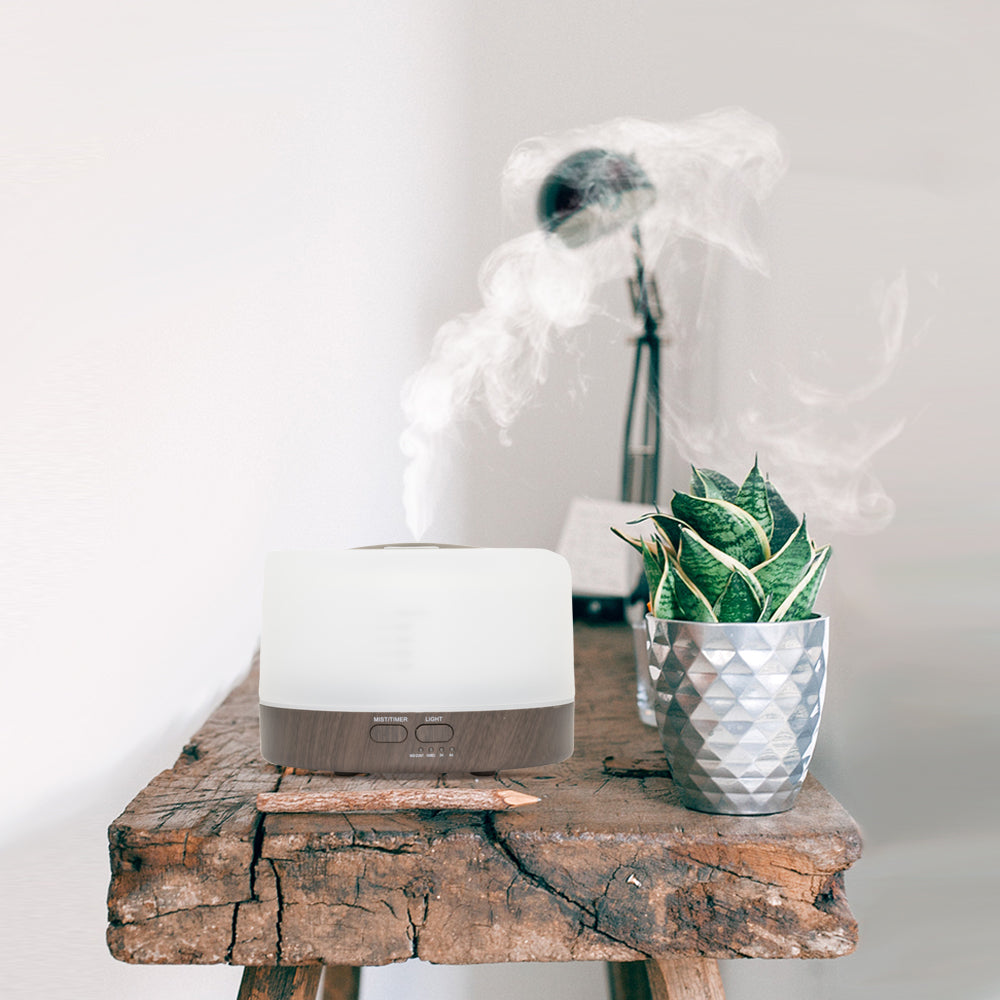 Moderne aroma diffuser met een eenvoudig rechthoekig design en houtafwerking. Voorzien van afstandsbediening, verstelbare timeropties (100 sec, 2 uur, 4 uur) en een zachte LED-verlichting voor een rustgevende sfeer.